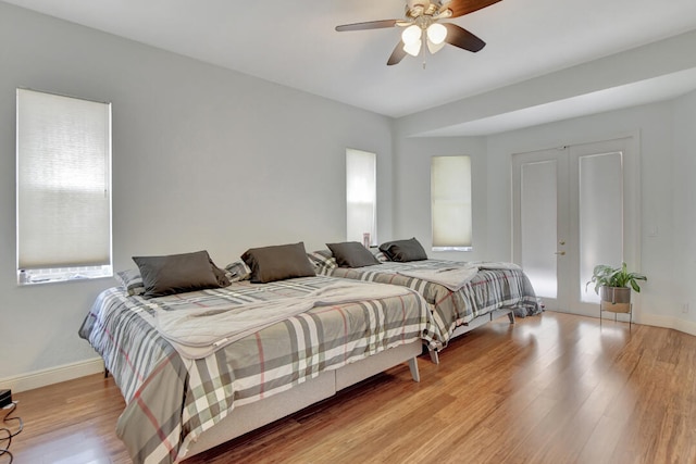 bedroom with ceiling fan, light hardwood / wood-style flooring, and french doors