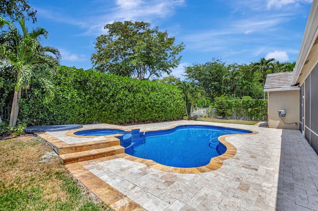 view of swimming pool with a patio and an in ground hot tub