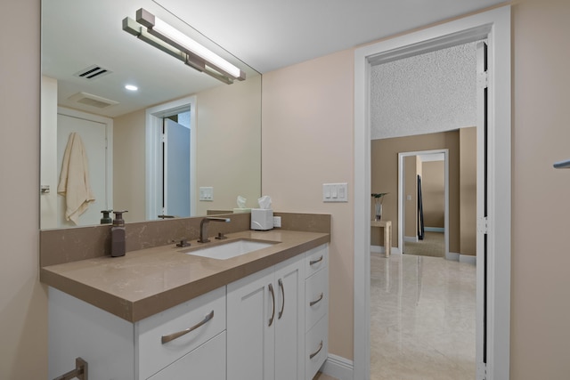 bathroom with tile floors, a textured ceiling, and vanity