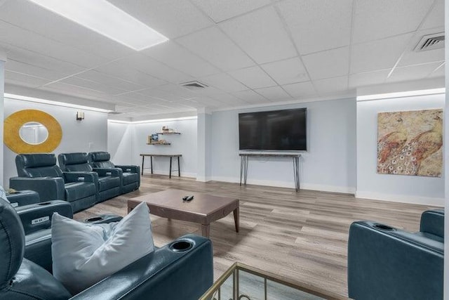 living room featuring hardwood / wood-style flooring and a paneled ceiling