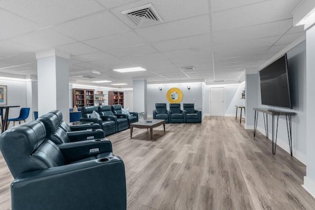 living room featuring a drop ceiling and wood-type flooring