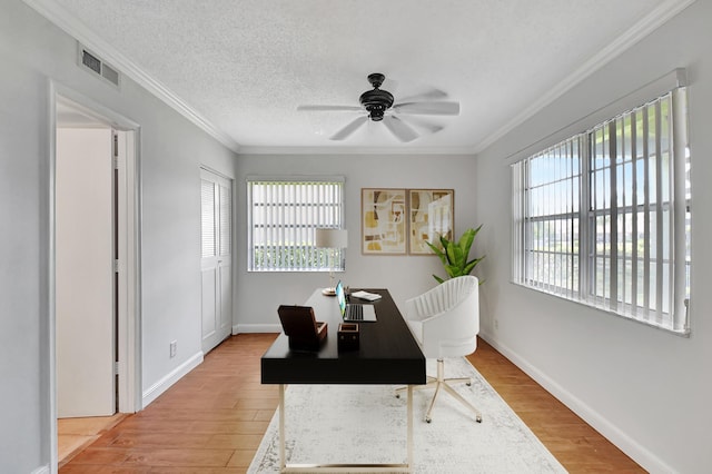 home office with crown molding, light hardwood / wood-style flooring, ceiling fan, and a textured ceiling