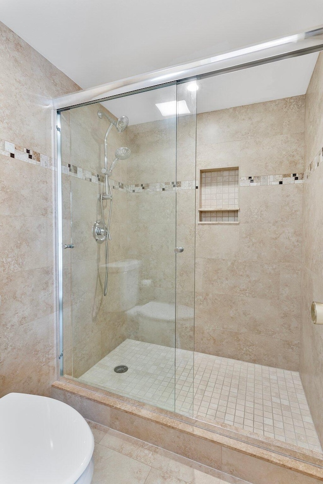 bathroom with a shower with door