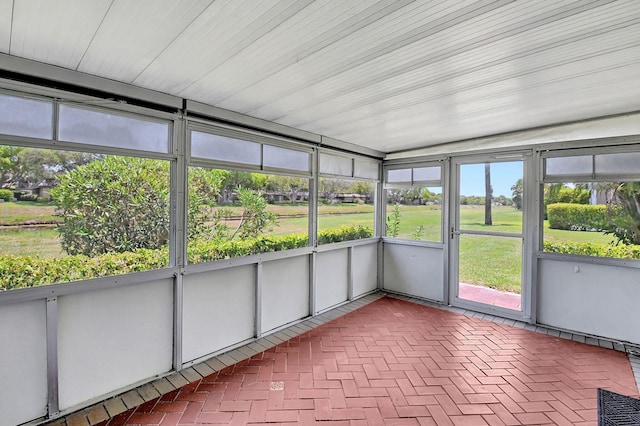 unfurnished sunroom with lofted ceiling