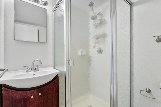 bathroom with vanity and a shower with shower door