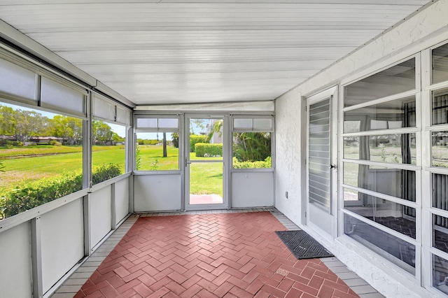 unfurnished sunroom with lofted ceiling