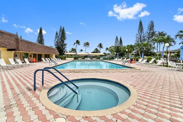 view of swimming pool with a community hot tub and a patio