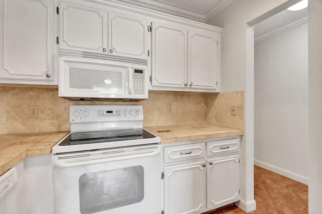 kitchen with white cabinetry, tile counters, white appliances, decorative backsplash, and light tile patterned flooring