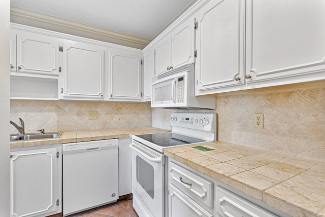 kitchen featuring white cabinetry, white appliances, sink, and tasteful backsplash