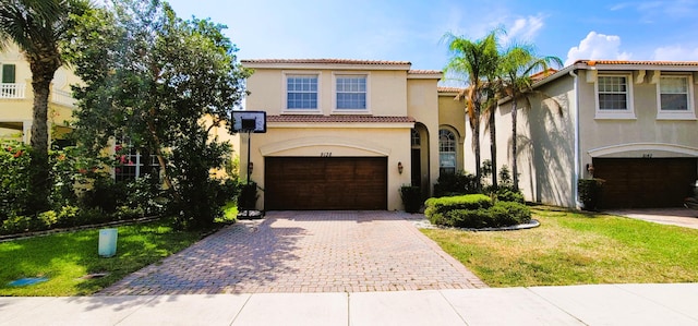 mediterranean / spanish-style home featuring a garage and a front lawn