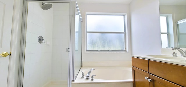 bathroom with shower with separate bathtub and large vanity