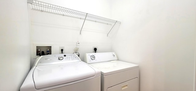 laundry room featuring separate washer and dryer, washer hookup, and electric dryer hookup