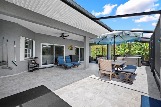 view of patio / terrace with ceiling fan and a hot tub