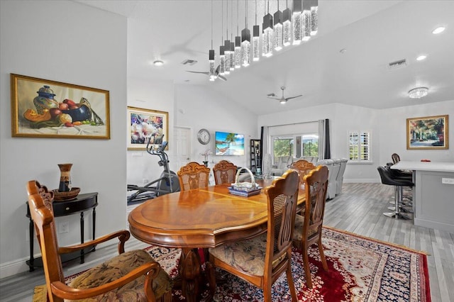 dining room featuring ceiling fan, light hardwood / wood-style flooring, and lofted ceiling