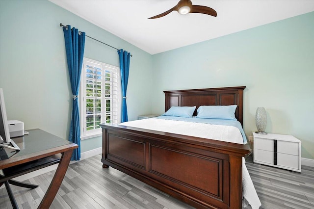 bedroom with wood-type flooring and ceiling fan