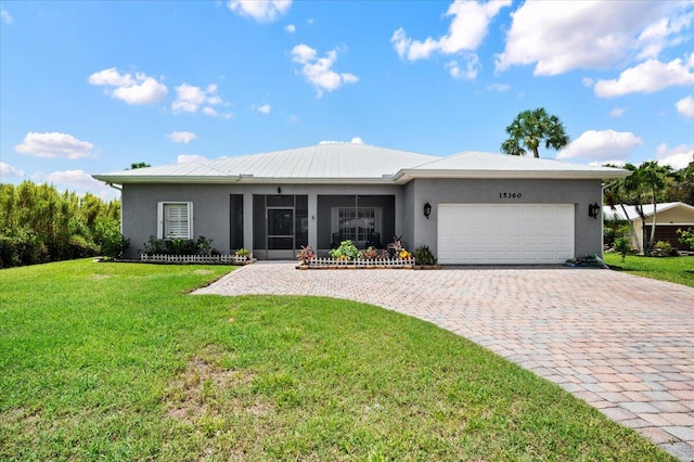 ranch-style home with a garage and a front lawn