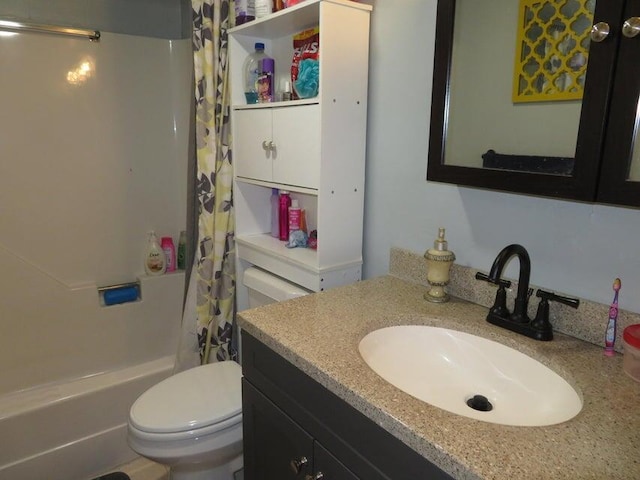 full bathroom featuring shower / bathtub combination with curtain, vanity with extensive cabinet space, and toilet