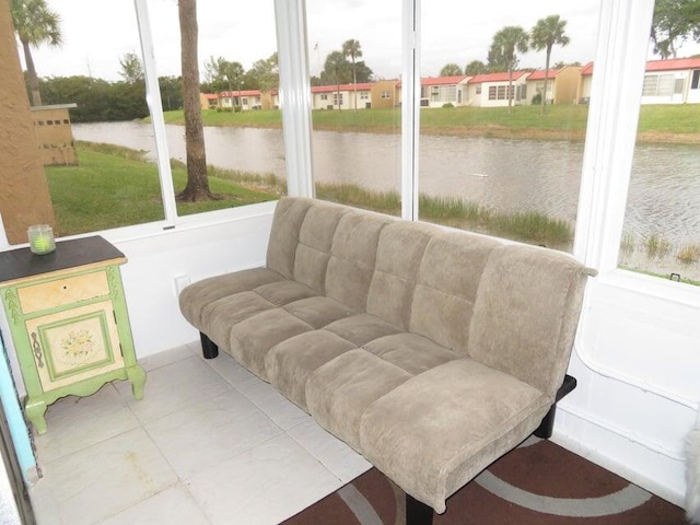 sunroom featuring a healthy amount of sunlight and a water view