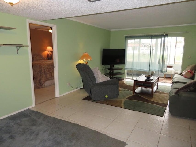 living room with tile flooring, ornamental molding, ceiling fan, and a textured ceiling