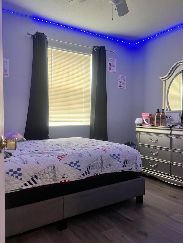 bedroom with dark wood-type flooring and ceiling fan