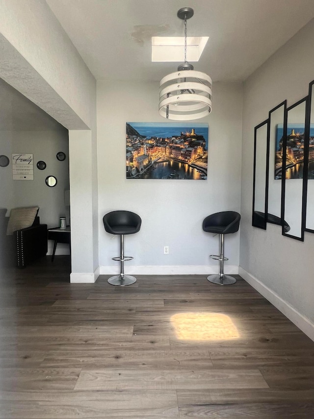 unfurnished dining area with hardwood / wood-style flooring and a notable chandelier