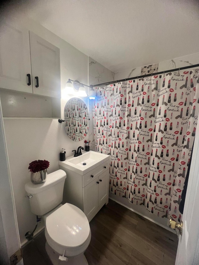 bathroom featuring vanity, hardwood / wood-style flooring, and toilet