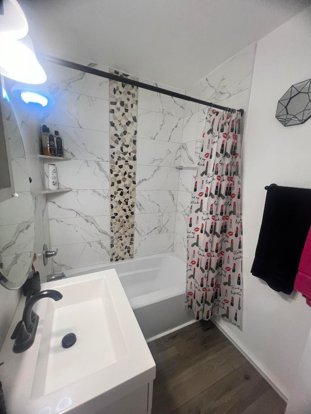 bathroom with wood-type flooring, vanity, and shower / bath combination with curtain