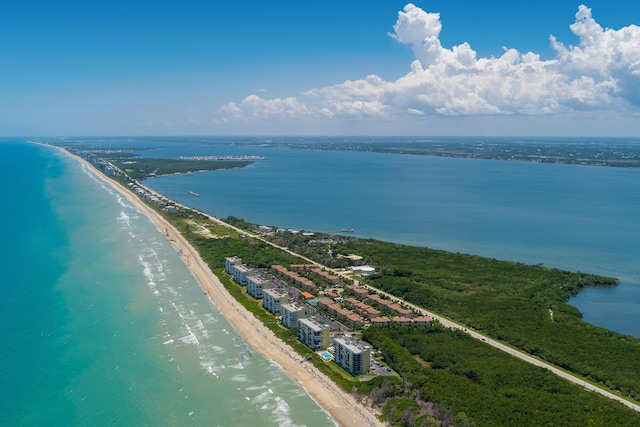 aerial view with a water view and a beach view