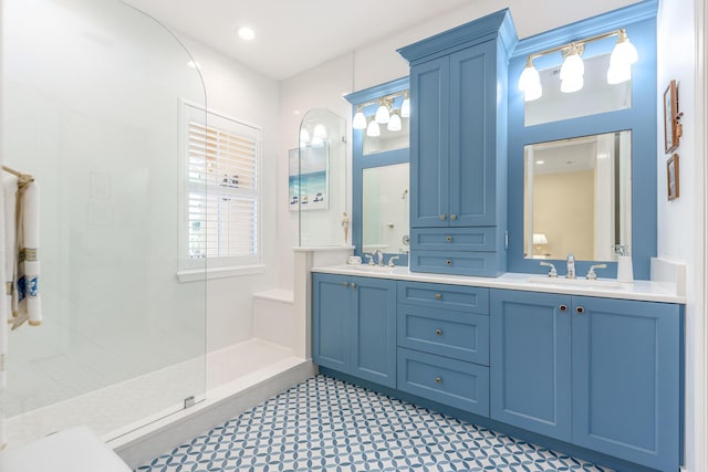 bathroom with vanity and tiled shower