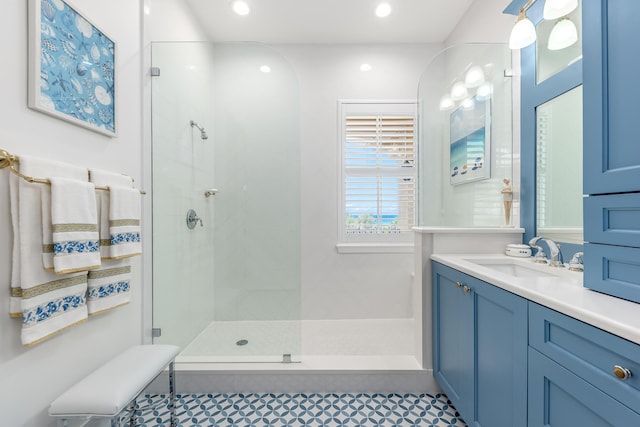 bathroom with vanity and a shower with shower door