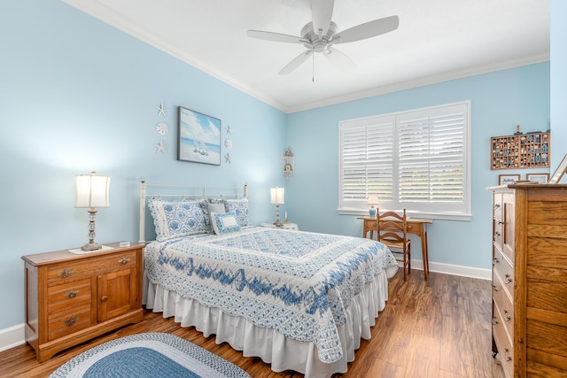 bedroom featuring ceiling fan, wood-type flooring, and crown molding