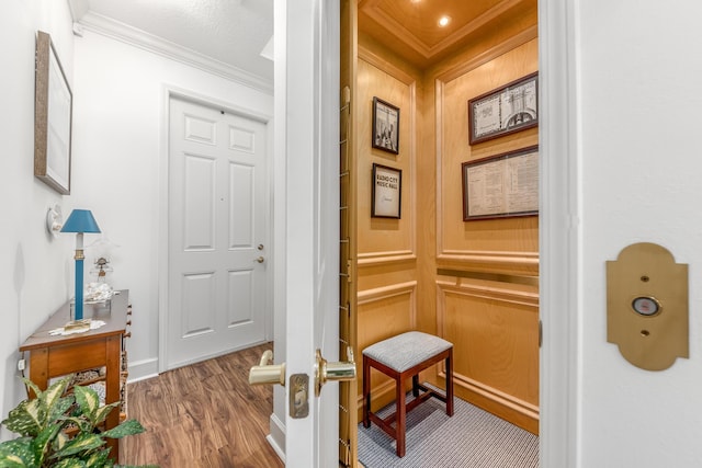 corridor with crown molding and hardwood / wood-style flooring