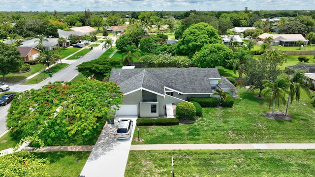 single story home featuring a front yard and a garage