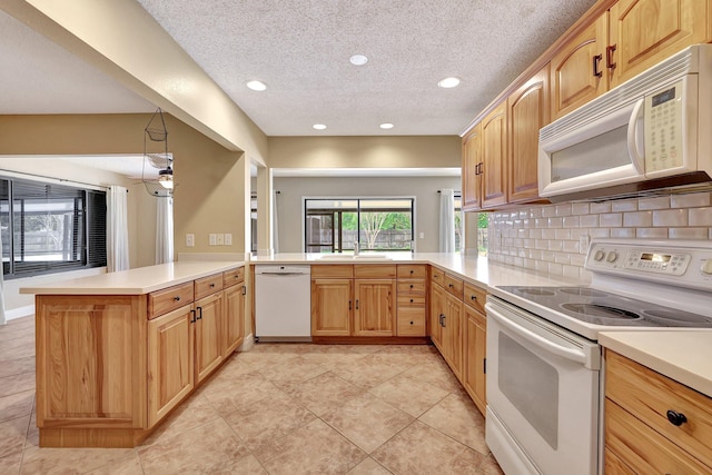 kitchen featuring kitchen peninsula, light tile patterned floors, backsplash, a textured ceiling, and white appliances