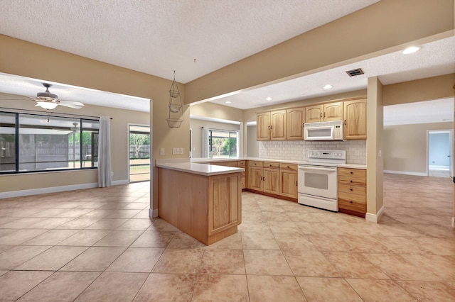 kitchen with kitchen peninsula, tasteful backsplash, hanging light fixtures, a textured ceiling, and white appliances