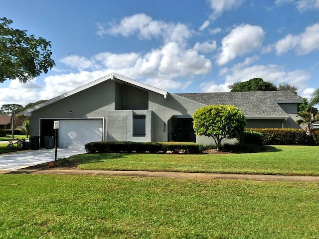 single story home with a front yard and a garage