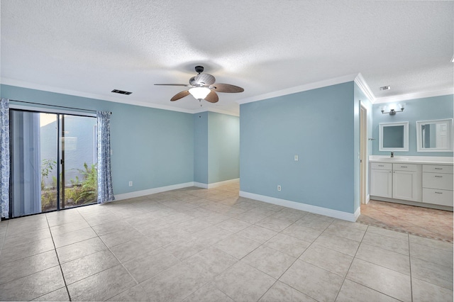 tiled spare room featuring ornamental molding, sink, a textured ceiling, and ceiling fan