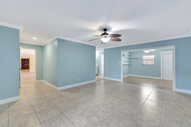 spare room with ornamental molding, a textured ceiling, light tile patterned floors, and ceiling fan