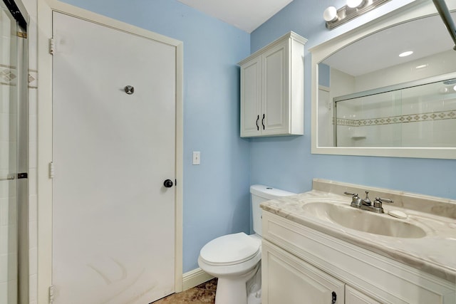 bathroom featuring vanity, toilet, and walk in shower