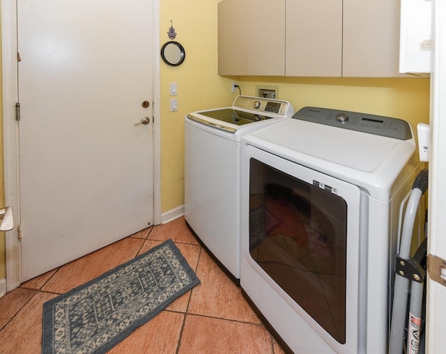 washroom with separate washer and dryer and light tile patterned flooring