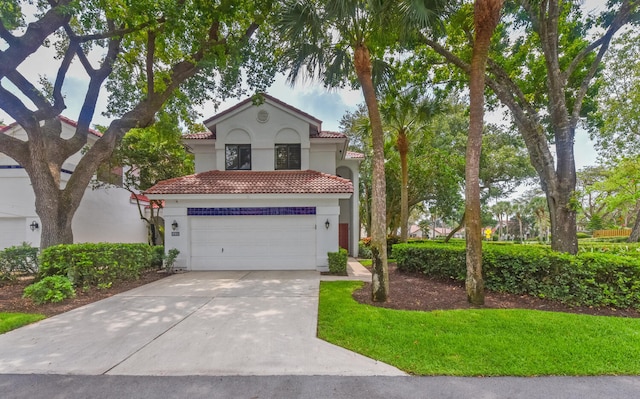 mediterranean / spanish home featuring a garage