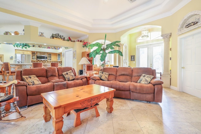 living room with french doors, a raised ceiling, crown molding, and a notable chandelier