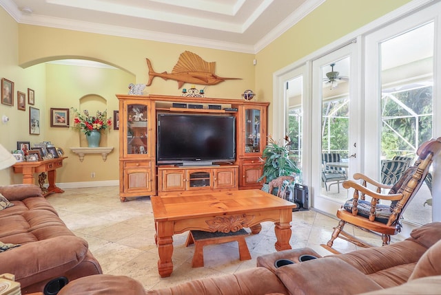 tiled living room with ceiling fan and crown molding