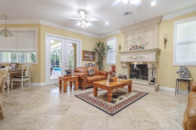 living room with a fireplace, ceiling fan, french doors, and crown molding