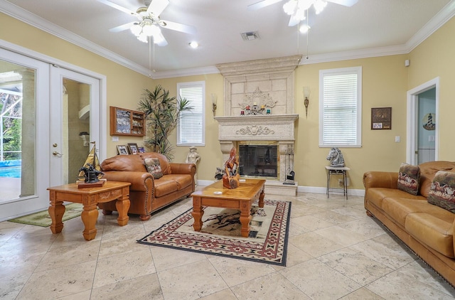 living room featuring a large fireplace, ceiling fan, french doors, and ornamental molding