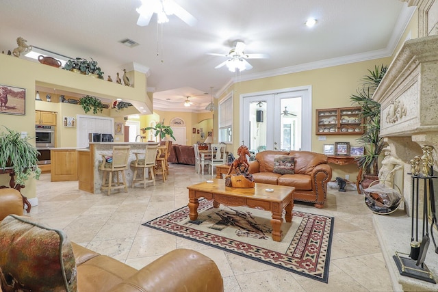 living room featuring crown molding, french doors, and ceiling fan