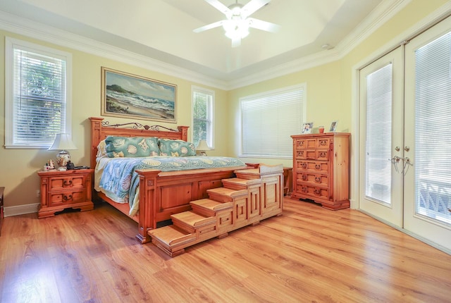 bedroom with access to outside, multiple windows, ceiling fan, and french doors