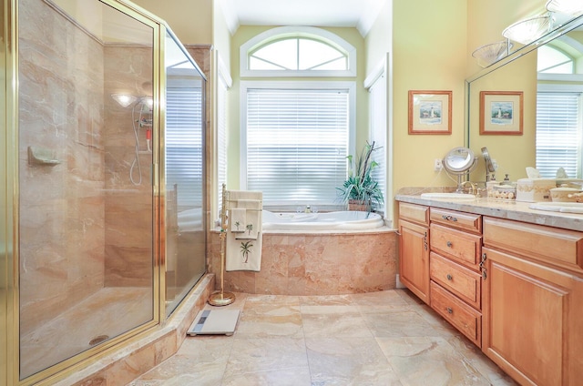 bathroom with vanity and independent shower and bath