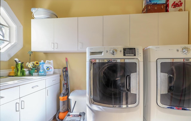 laundry area with cabinets and separate washer and dryer