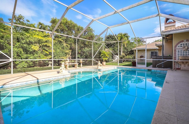 view of swimming pool featuring a lanai and a patio